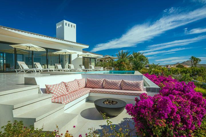 Sunken fire-pit lounge framed by magenta bougainvillea on the terrace at Casa Alba
