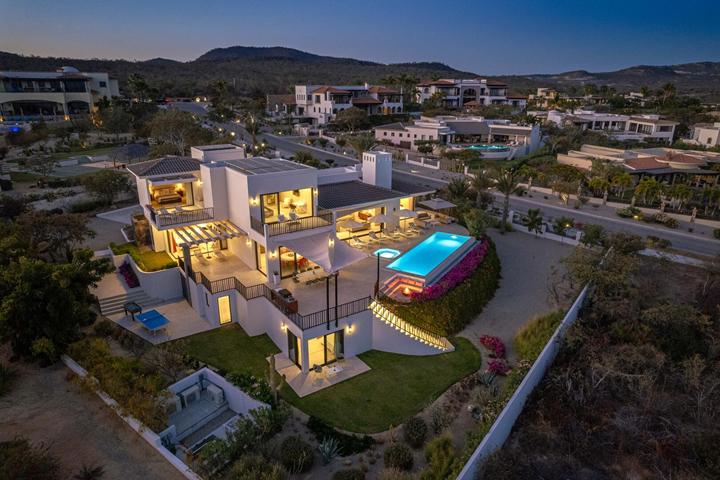 Aerial view of a contemporary villa among hillside homes in Puerto Los Cabos at dusk