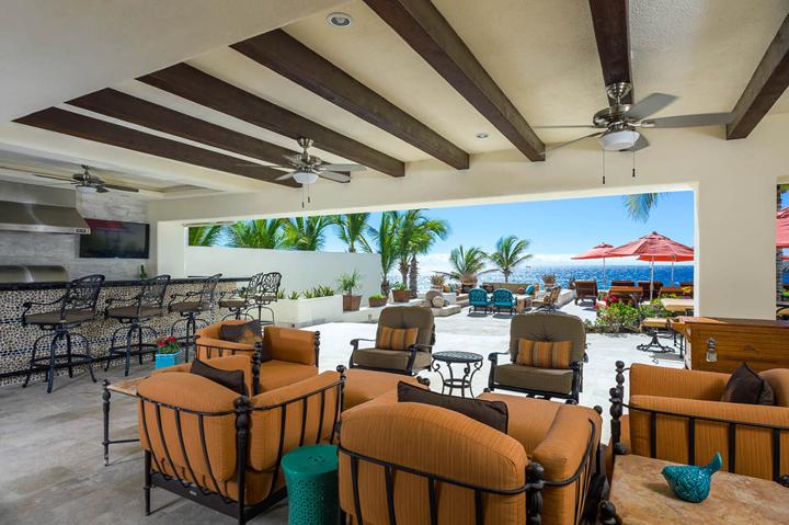 Covered outdoor lounge at Casa Alcini opening onto the pool terrace