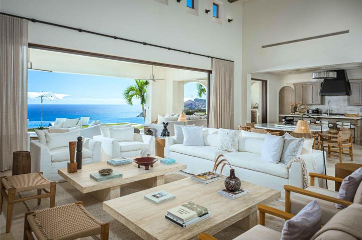 Bright great room with sofas, coffee tables and the kitchen beyond at Casa Catrina