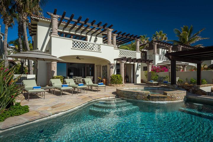 Beachfront villa facade with balconies and pergolas above a pool in San José del Cabo