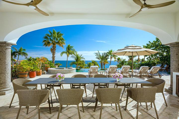 Covered outdoor dining for a large group with ocean views at Casa de las Risas