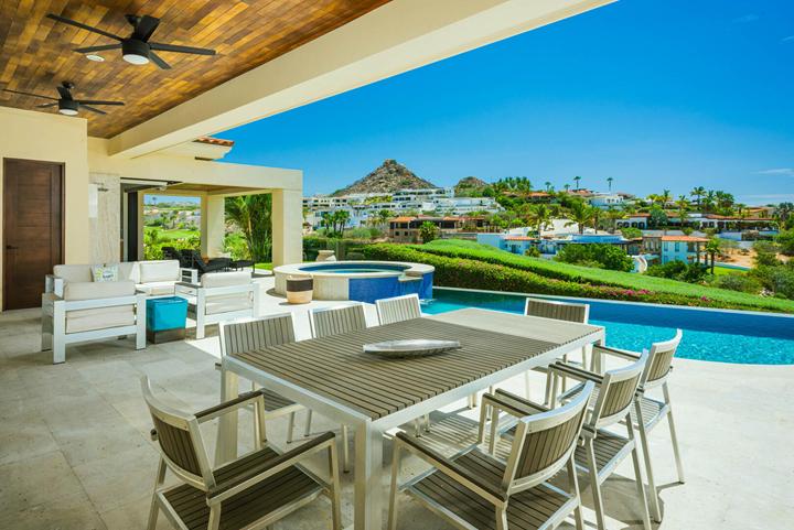 Covered outdoor dining and lounge beside the pool at Casa Isabelle