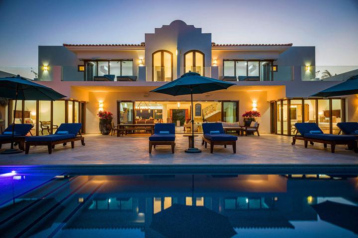 Villa Bahia de los Frailes lit at dusk above its pool terrace