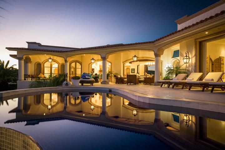 Villa Buena Vida at twilight, reflected in its pool