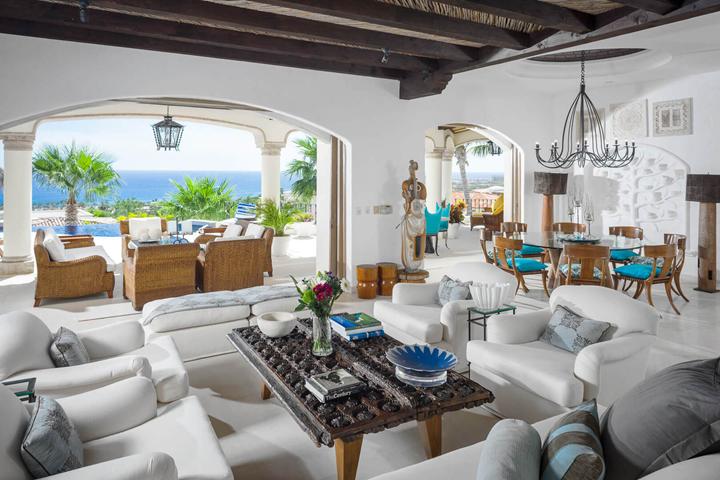Living room with arched openings to the terrace at Villa Buena Vida